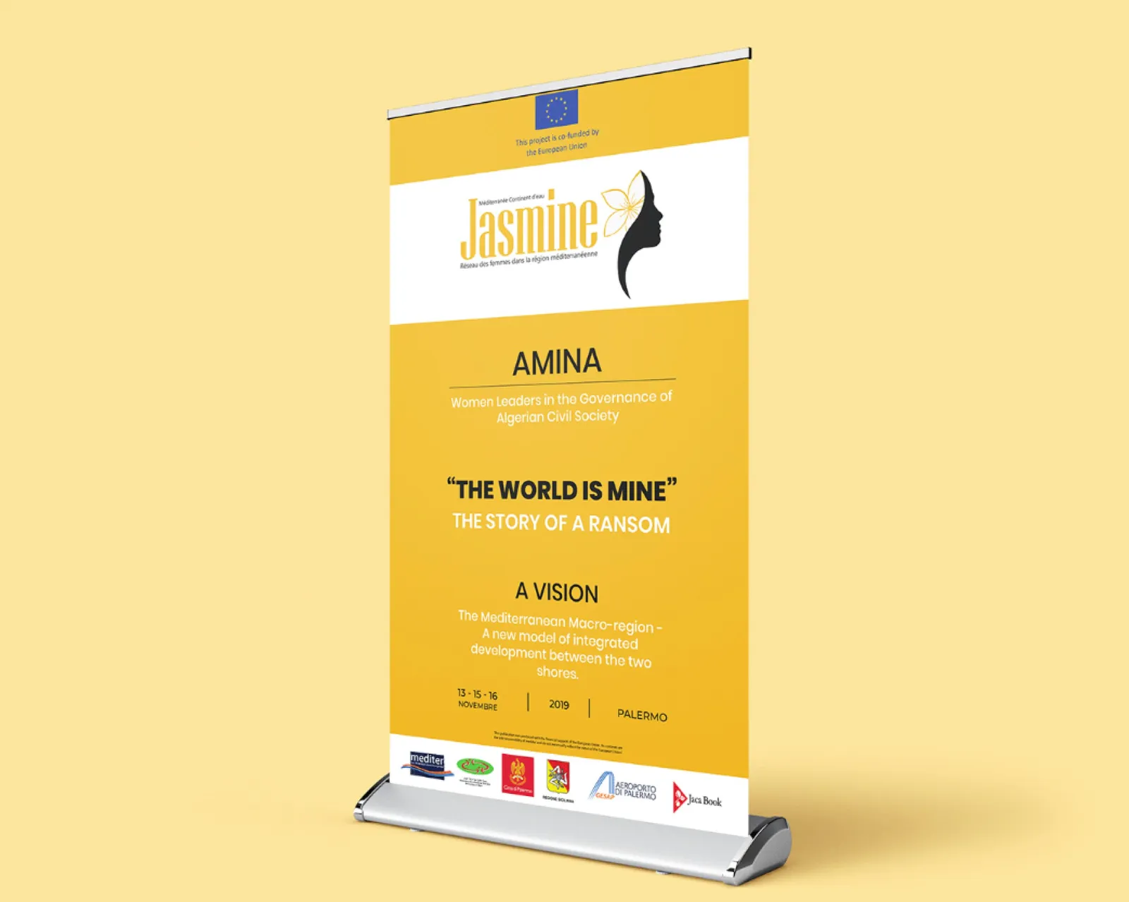 A yellow roll-up banner for AMINA and “The World Is Mine”, with partner logos
